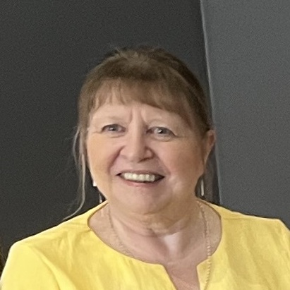 Smiling woman in yellow blouse indoors